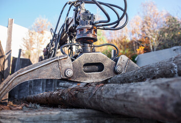 Open jaws of a crane grab loader tractor machine