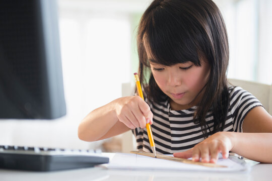 Filipino girl drawing at computer