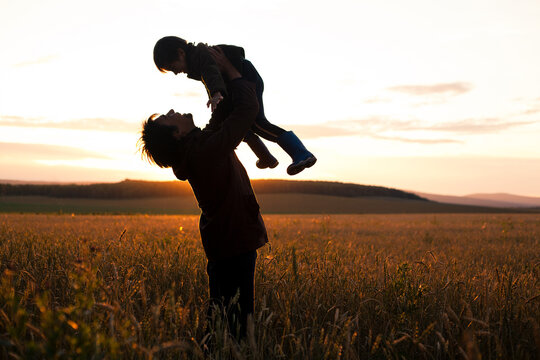 Mari father and son playing in rural field