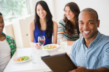 Man handing check to server at restaurant