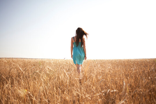 Caucasian Woman Walking In Rural Field