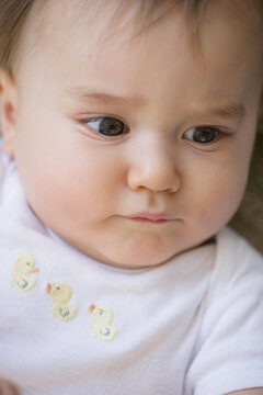 Close up of confused mixed race baby