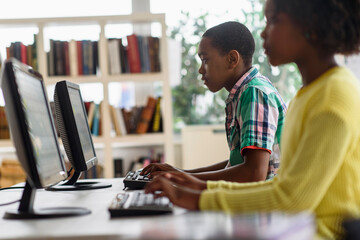 Black students using computers in classroom