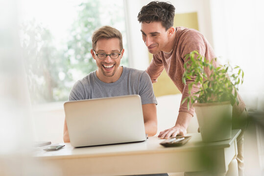 Caucasian gay couple using laptop