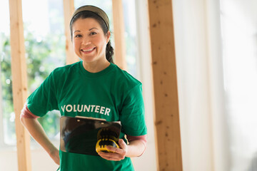 Mixed race volunteer helping build house