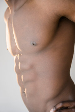 Black man flexing abdominal muscles