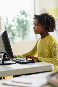 Black student using computer in classroom
