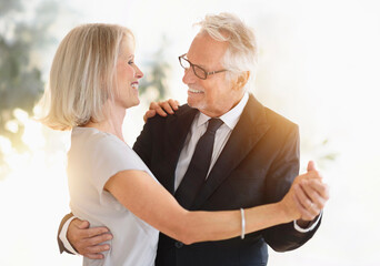 Smiling older Caucasian couple dancing