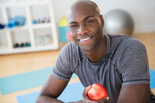 Black Man Eating Apple In Gym