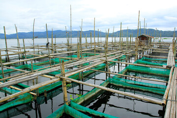 Fototapeta premium North Sulawesi, Indonesia, June 17, 2015. Freshwater culture cages are built by residents along the outskirts of Lake Tondano.