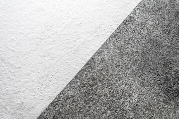 Fototapeta premium The Black and White Colored Wall is Divided into Two Diagonal Parts. Close Up Natural Background for the Text Placement.
