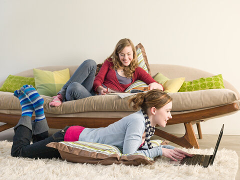 Caucasian women reading in living room