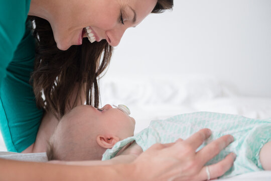 Mother playing with baby daughter