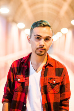 Serious Hispanic man wearing flannel shirt