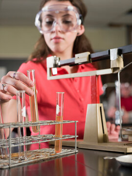 Student Examining Sample In Science Lab Classroom