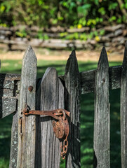 Historic old lock rusty on fence gate ancient