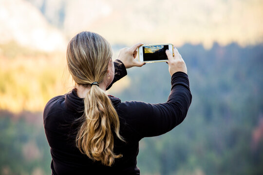 Caucasian woman photographing Yosemite National Park, California, United States