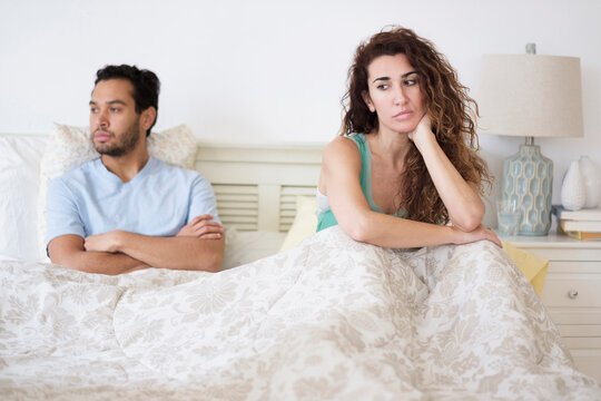 Couple arguing in bed
