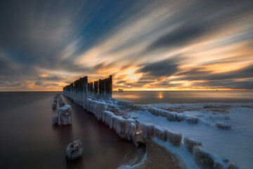 Winter Baltic Sea, view of the palisade made of tree trunks, Gdynia, Poland