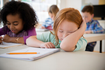 Frustrated student working in classroom