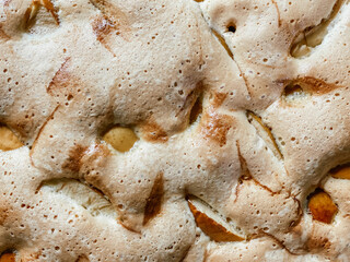 The close up of the cooked sponge cake with apples, top view. Food textures.
