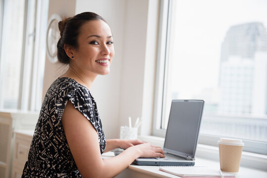 Businesswoman working on laptop in office