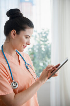 Caucasian nurse using digital tablet