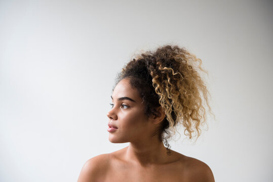 Mixed Race woman with bare shoulders looking away