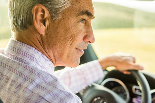 Serious Caucasian businessman driving car