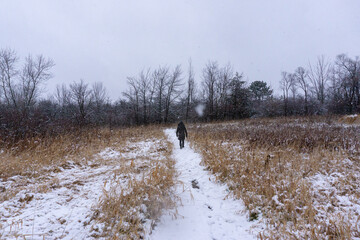 Woman walks away from camera in snow