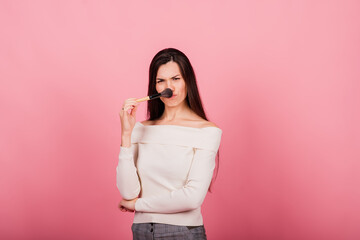 Cosmetologist beautician holding a tool in her hands, permanent makeup master, permanent makeup