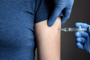 Doctor makes COVID-19 corona virus vaccine injection to woman patient