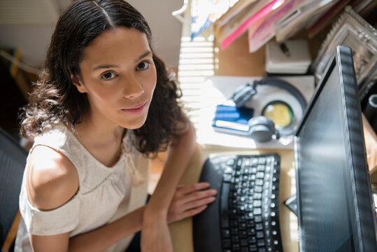 Portrait of Hispanic woman using computer