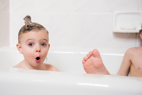 Surprised Caucasian girl in bubble bath