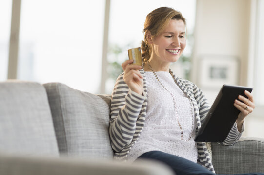 Woman holding tablet pc and credit card