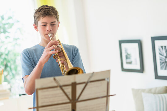 Teenage boy (16-17) playing trumpet