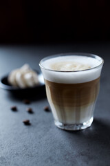 Coffee with milk on dark stone background. Close up.	