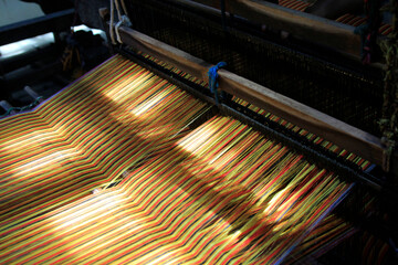 The beauty of the color of the woven fabric when it is being processed on a manual loom instead of...