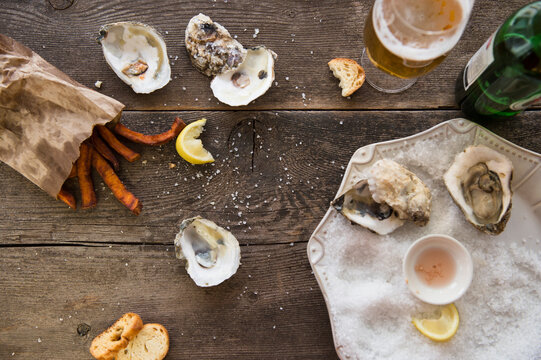 Studio shot of glass of beer, oysters and french fries