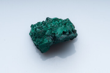 Malachite green ore on a white background. Natural green malachite