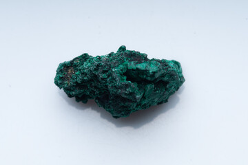 Malachite green ore on a white background. Natural green malachite