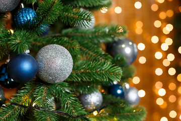 Beautiful Christmas tree decorated with blue and silver toys. New Years is soon. Decorations for Christmas Day