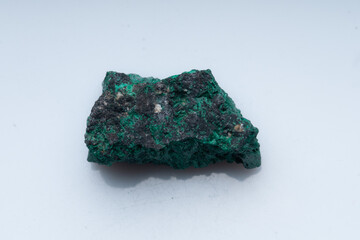 Malachite green ore on a white background. Natural green malachite