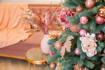 Christmas tree with pink toys in a white Christmas room. Beautifully decorated house with a decorated Christmas tree for the new year