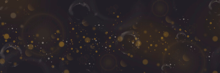 Yellow bokeh and lens flare on a dark background. Stars and spots. Defocused