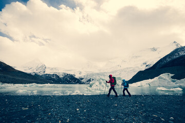 Naklejka premium Two women hikers hiking in winter mountains
