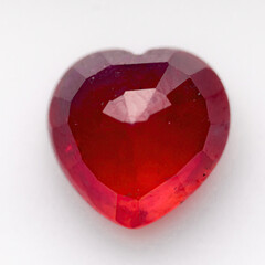 Natural ruby in the shape of a heart on a white background