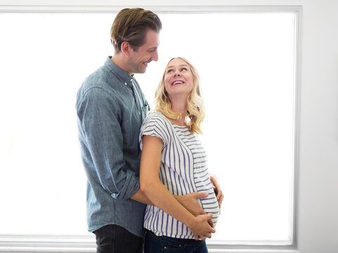 Husband embracing pregnant wife