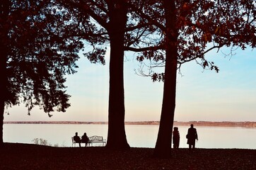 View of Seneca Lake (one of Finger Lakes) at sunset. Group of people enjoying the natural scene,...