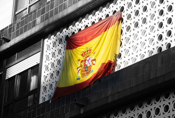 lag of spain hanging on a balcony